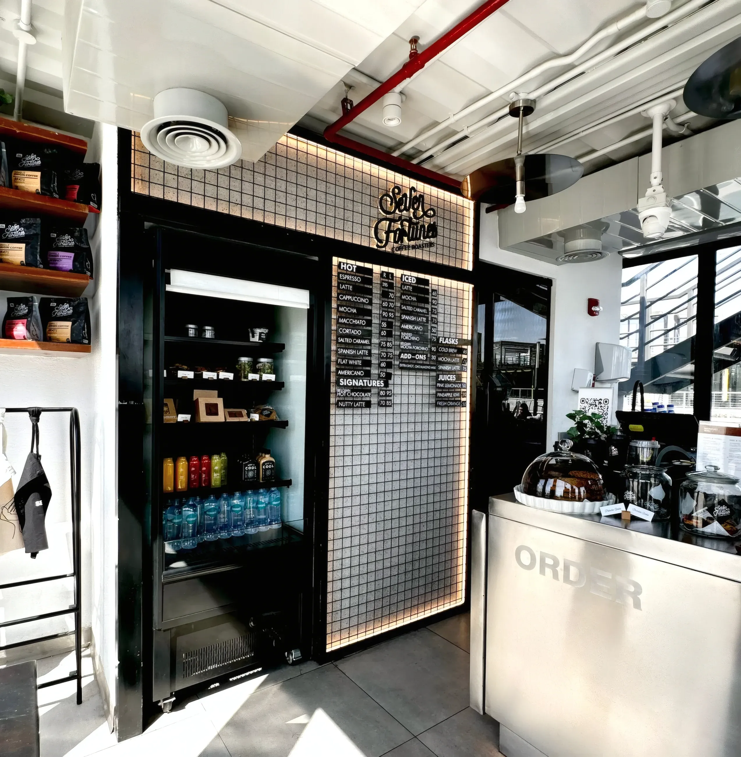 Marble counter and blackened steel fittings inside a specialty coffee shop